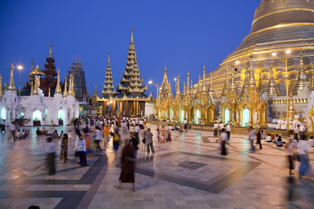 The biggest Buddhist temple Shwedagon pagoda at night lighting with praying Buddhist people, Rangoon, Burma.のeditorial素材