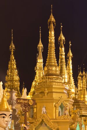 Interior of the biggest Buddhist temple Shwedagon pagoda at night lighting, Rangoon, Burma.の写真素材