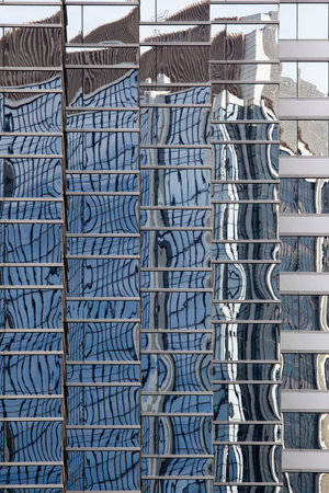 HONG KONG - FEBRUARY 2, 2013: Reflections in glass-metal facade of skyscraper in Hong Kong downtown.
