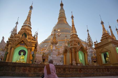 BURMA, RANGOON, SHWEDAGON PAGODA - FEBRUARY 11, 2011: Monk woman in the biggest Buddhist temple Shwedagon pagoda.のeditorial素材
