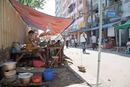 BURMA, RANGOON - FEBRUARY 13, 2011: Woman is living on the street under temporary tent.のeditorial素材