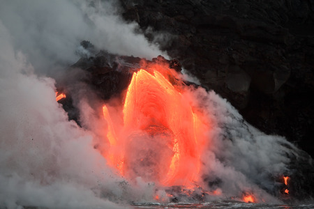 Hot lava stream is flowing into the ocean. Hawaii, Big Island.の写真素材