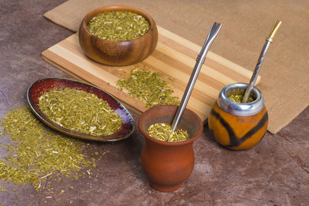 Close up yerba mate in calabash, in porongo and in bowls