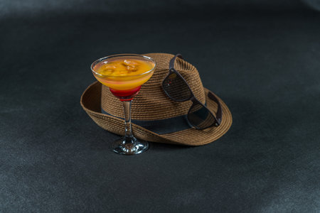 colored drink, a combination of red orange, lemon, martini glass, brown sunglasses, a brown hat, party setの写真素材