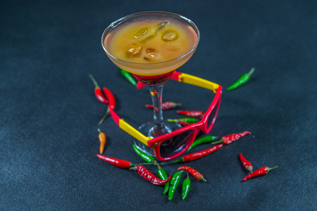colored drink, a combination of red orange, lemon, martini glass, brown sunglasses, red and green peppers, party setの写真素材