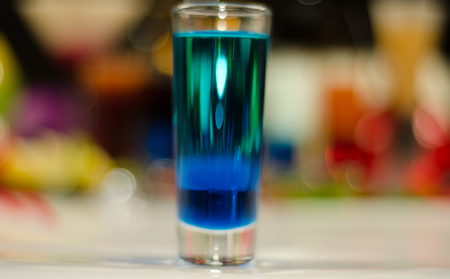 colored drink in glass for shots, a combination of green with blue, colorful background, drink shotの写真素材