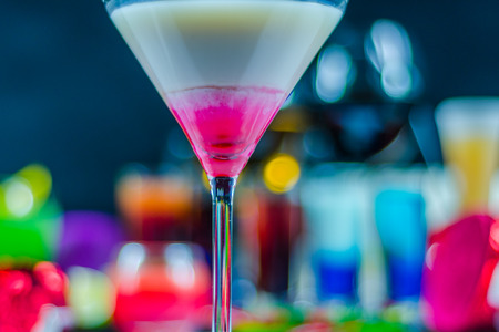 colored drink in a martini glass, a combination of white with pink colored background, drink setの写真素材
