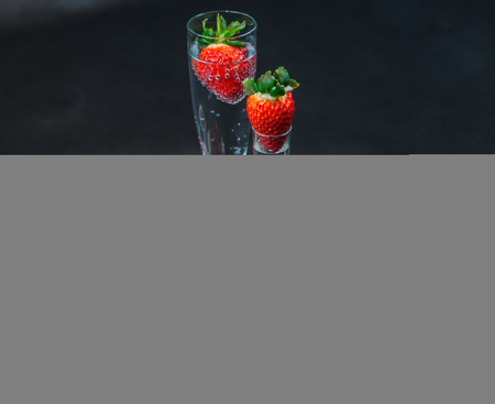 Black coffee in white cup, with croissants on saucer, sparkling wine and vodka, strawberry, tasty setの写真素材