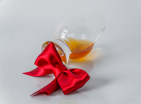 single malt whiskey glass with red bow on a white background, wkisky single maltの写真素材
