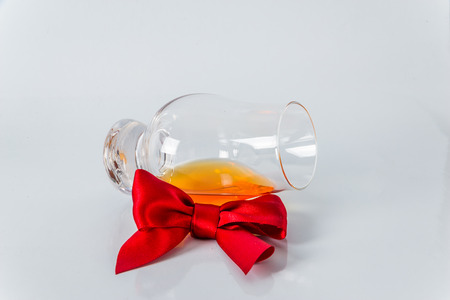 single malt whiskey glass with red bow on a white background, wkisky single maltの写真素材