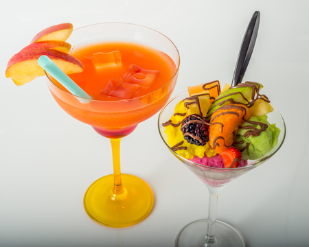 Fruit ice cream, decorated with fresh fruit, chocolate covered, orange drink, margarita glass, summerの写真素材