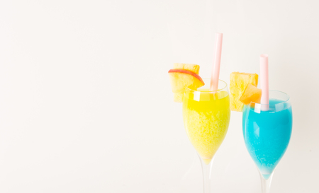 yellow and blue drinks decorated with fruit, drink straw, apple and melon, summer setの写真素材