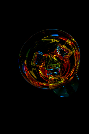 Colorful drink in a cocktail glass, with ice cubes, summer drink, party nightの写真素材