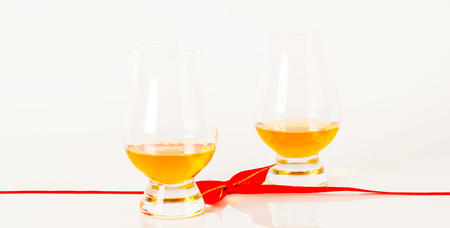 Set of single malt tasting glasses, single malt whisky in a glasses, white background, red bow, exclusive setの写真素材