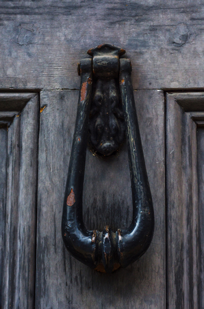 Door with brass knocker in the shape of a hand, beautiful entrance to the house, home decorの写真素材