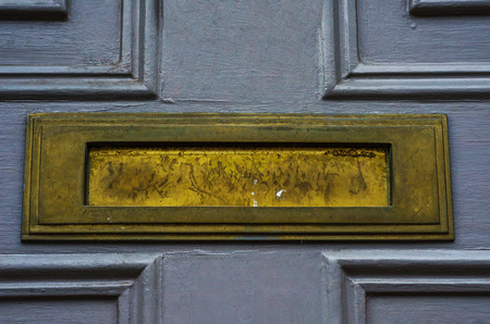 Old letterbox in the door, traditional way of delivering letters to the house, old mailbox, correspondenceの写真素材