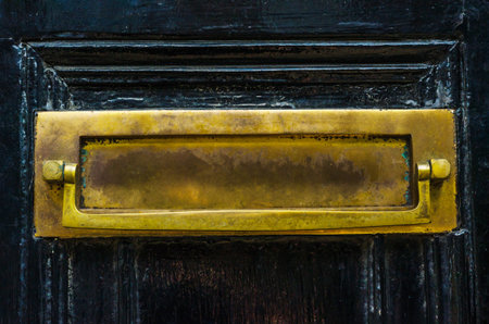 Old letterbox in the door, traditional way of delivering letters to the house, old mailbox, correspondenceの写真素材