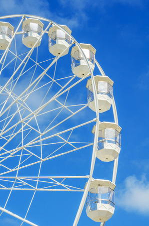 big wheel in the seaside village, in the background clean blue sky, sunny dayの写真素材