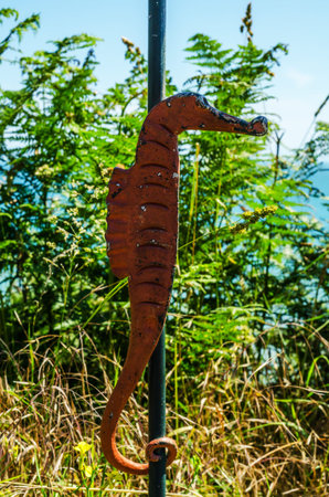 Metal ornament on a balustrade in a seaside village, symbolic in the shape of a seahorse, decorの写真素材