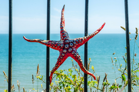 Metal ornament on a balustrade in a coastal town, a symbolic starfish shaped element, decorの写真素材