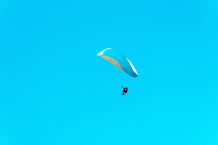 Paraglider flying in the sky, free time spent actively, wonderful experiences, vacationの写真素材