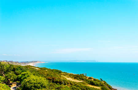 Ocean view with hills, green vegetation background and beautiful blue ocean tile, vacationの写真素材