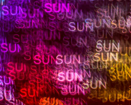 Beautiful background with different colored word sun, abstract background, sun shapes on black background, blurryの写真素材