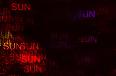 Beautiful background with different colored word sun, abstract background, sun shapes on black background, blurryの写真素材