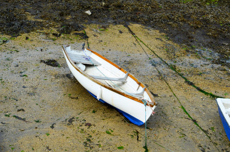 Boats  in a little harbor during an outflow, low water level, fishing industry