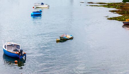 Boats and ships moored in a small port, in the background coastal town, fishing industry and tourism, shipsの写真素材