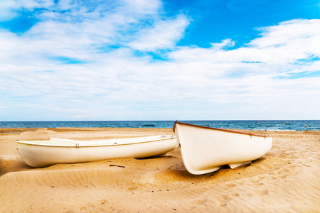 boat on the sand, beautiful sandy beach, boat for leisure and fishing, sunny dayの写真素材
