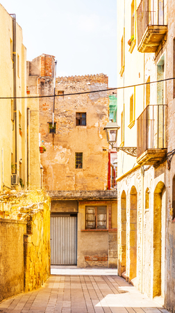 Charming narrow street, street with colorful facades of buildings, vintage style, sunny dayの写真素材