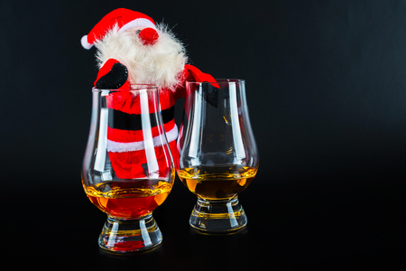 Santa Claus with single malt whiskey glass, Symbol of Christmas holiday, Xmas set, decorationの写真素材