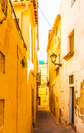 Beautiful, picturesque street, narrow road, colorful facades of buildings, Spanish architecture, sunny dayの写真素材