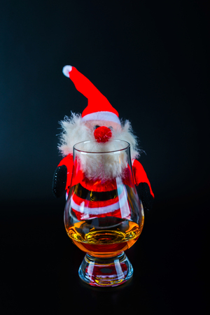 Santa Claus with single malt whiskey glass, Symbol of Christmas holiday, Xmas set, decorationの写真素材