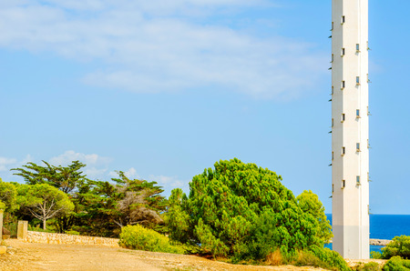 Lighthouse tower and blue summer sky, the safe return of the ship, maritime safety, high towerの写真素材