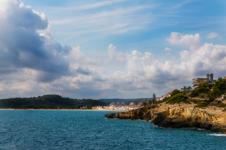 high cliff above the sea, summer sea background, many splashing waves and stone, sunny dayの写真素材