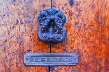 Door with brass knocker in the shape of a decor,  beautiful entrance to the house, vintage decorationの写真素材