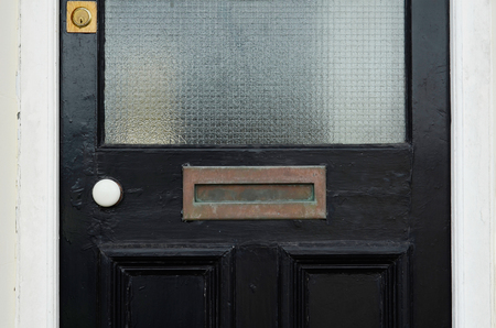 Old letterbox in the door, traditional way of delivering letters to the house, old mailbox, correspondenceの写真素材