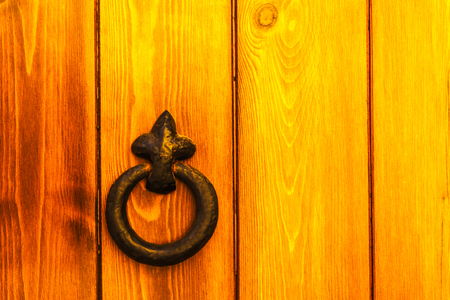 Door with brass knocker in the shape of a decor,  beautiful entrance to the house, vintage decorationの写真素材