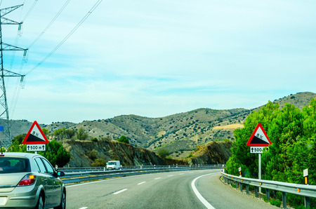 Fast road in the mountains in Spain, beautiful landscape of mountains, dry earth and rock from the sun, transportationの写真素材