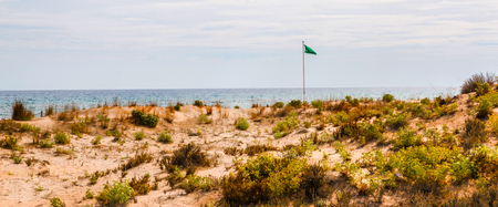 beach dunes in the sun, beach scene with copy space, sand dunes with blue sea and bright sun, vacationの写真素材