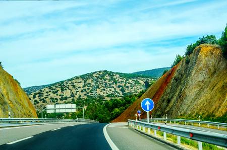 Fast road in the mountains in Spain, beautiful landscape of mountains, dry earth and rock from the sun, transportationの写真素材