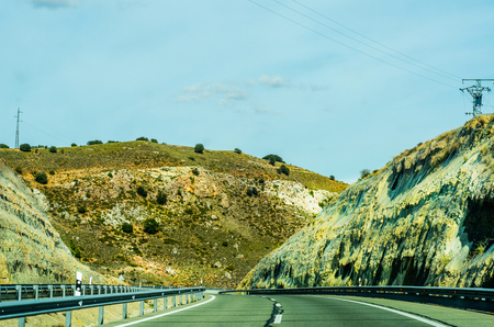 Fast road in the mountains in Spain, beautiful landscape of mountains, dry earth and rock from the sun, transportationの写真素材