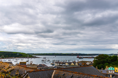 Roofs of buildings covered with sar roof tile, beautiful English architecture, ocean, cloudy dayのeditorial素材