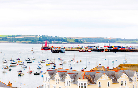 Roofs of buildings covered with sar roof tile, beautiful English architecture, ocean, cloudy dayの写真素材