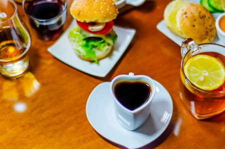 mini burgers with meat, vegetables, cheese and other toppings, bread sprinkled with sesame seeds, mini fast food, tasty setの写真素材