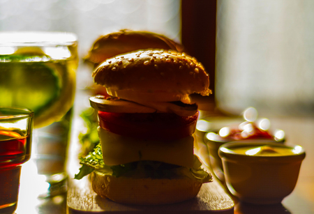 mini burgers with meat, vegetables, cheese and other toppings, bread sprinkled with sesame seeds, mini fast food, tasty setの写真素材