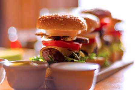 mini burgers with meat, vegetables, cheese and other toppings, bread sprinkled with sesame seeds,...