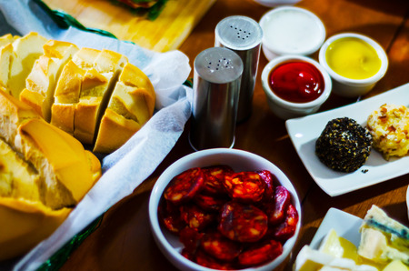 set of traditional Spanish sausages, side dishes of thinly sliced different chorizo, sets of meats, tasty mealの写真素材